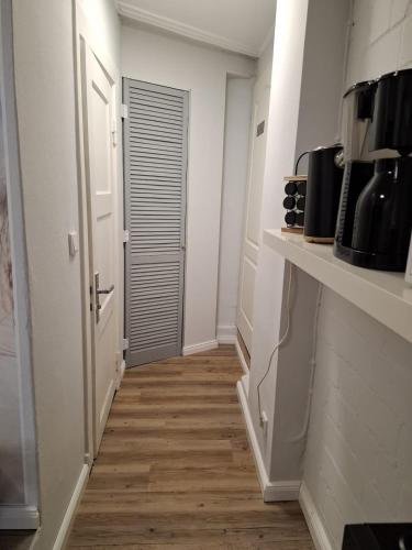 a room with a hallway with a door and a wooden floor at Fewo Apartment "Zur Düne" in Langelohe