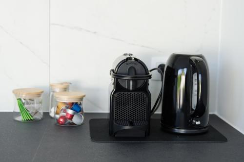 a black coffee maker sitting on a counter at Vakantiewoning Ten Huyze Bucholt met tuinsauna in Bocholt
