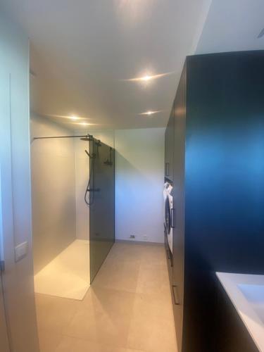 a hallway with a glass door in a room at Vakantiewoning Ten Huyze Bucholt met tuinsauna in Bocholt