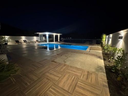 a swimming pool in the middle of a yard at night at Harmony House - Adults Only in Dubova
