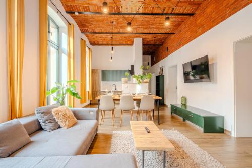 a living room with a couch and a table at L&C-Elbresidenzen & Suites am Elberadweg in Magdeburg