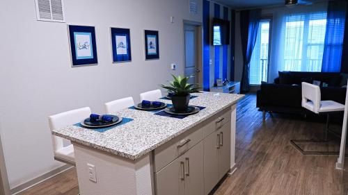 a kitchen with a island in a living room at Blue Waves Serenity 1BD Lux King - Southeast Jax in Jacksonville