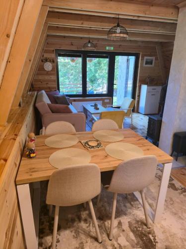 a wooden table and chairs in a living room at Basna FoRest in Žabljak