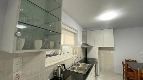 a small kitchen with a sink and a refrigerator at Relax in Loutraki in Loutraki