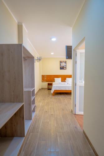 a large room with a bed and a bedroom at Hotel El Tambo de Tarapoto-Perú in Tarapoto