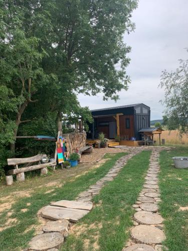 a woman standing in a yard with a house at Kleines Glück in Markt Nordheim