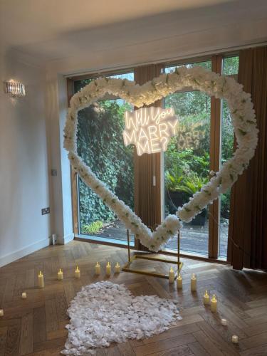 a heart shaped altar in a room with a large window at Luxury Riverside Retreat With Bath Jacuzzi in London