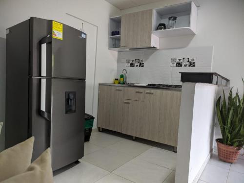 a kitchen with a stainless steel refrigerator and cabinets at Mami yola 2 in Valledupar