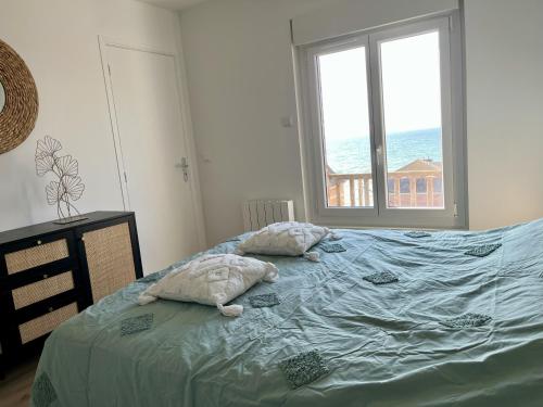 Appartement vue mer - 3ème étageにあるベッド