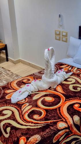 a bed with a white swan decoration on the floor at Summer Land Hotel in Abu Simbel