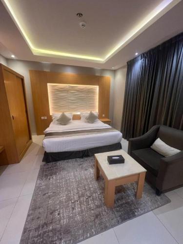 a hotel room with a bed and a couch at فندق أجنحة سمو - smo suites hotel in Riyadh
