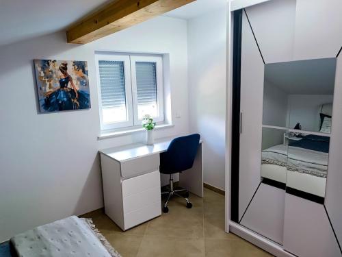 a bedroom with a desk and a bed and a mirror at Apartma LANA in Koper