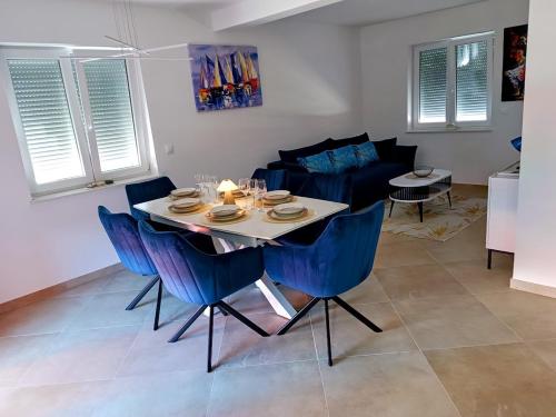 a dining room and living room with a table and chairs at Apartma LANA in Koper