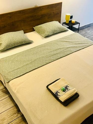 two beds with pillows and a towel on them at ViMaJU in Koper