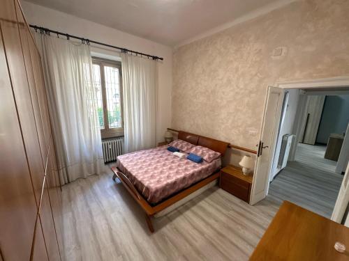 a small bedroom with a bed and a table at VSuite Linate in Milan