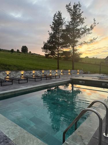 a swimming pool with a sunset in the background at Uvac lake "FF" in Sjenica