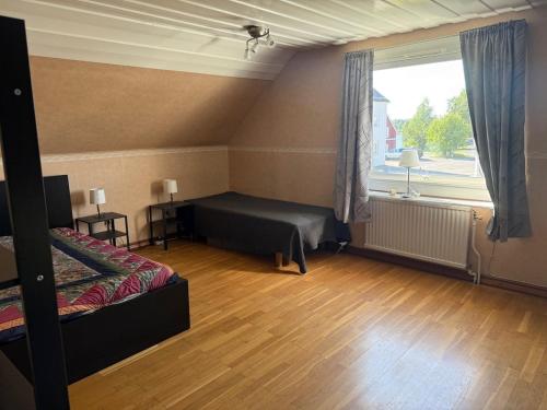 a bedroom with a bed and a large window at Villa Svartbyvägen in Boden