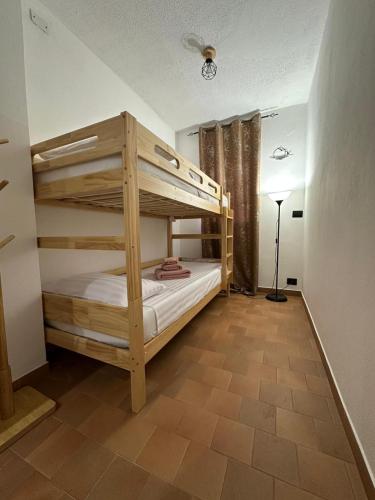 a bedroom with two bunk beds in a room at Villa Lollo in Camporosso