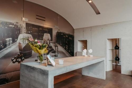 a room with a table with a vase of flowers on it at Daheim an der Lage in Obegg