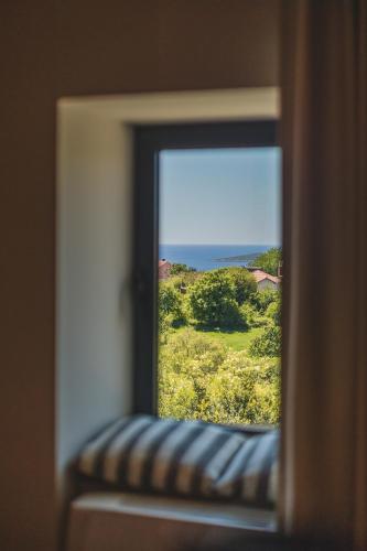 a window with a view of a field of flowers at Diamonte Villas Collection in Tivat