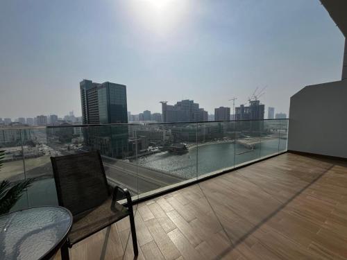 a balcony with a bench and a view of a city at 3BR Duplex Near Cleveland & Galleria Mall in Abu Dhabi
