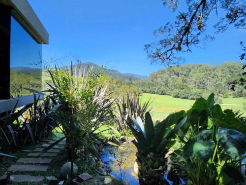 a garden with a view of a mountain at Cabana QUARTZO- Vista para PONTO TURISTIC0 Pedra Morro do Campestre- ACESSO até a cabana asfaltado in Urubici