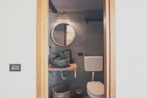 a bathroom with a sink and a mirror at Il fienile di Rosy in Ardenno