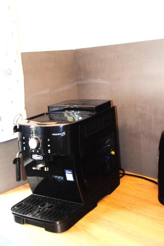 a black coffee maker sitting on top of a table at GraceHomes - Garage, Ventilator, Free Coffee, Airport, Messe, Stuttgart, WiFi up to 6 Guests in Leinfelden-Echterdingen