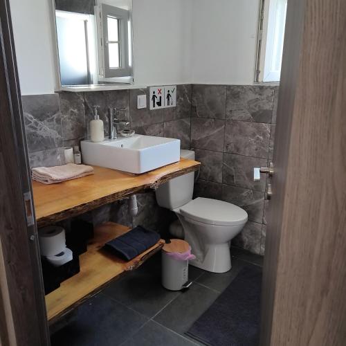 a bathroom with a sink and a toilet at Comfort house in Ermoupoli