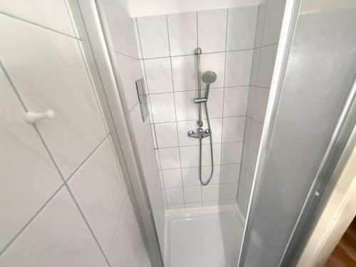 a shower with a shower head in a bathroom at Danube Holiday Rooms in Krems an der Donau