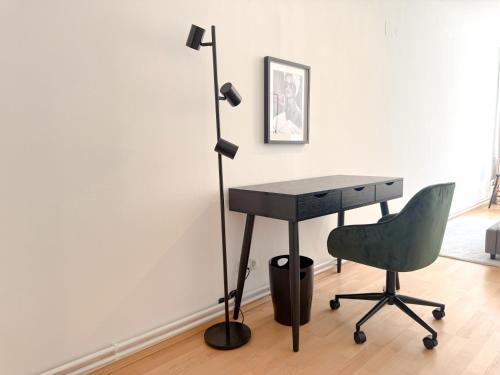 a desk and a chair in a room at Danube Holiday Rooms in Krems an der Donau