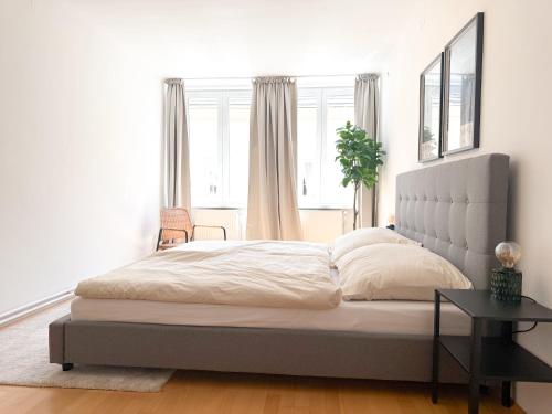 a bedroom with a large bed and a table at Danube Holiday Rooms in Krems an der Donau