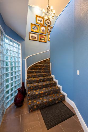 a staircase in a home with a blue wall at Prince's Gate Hotel in Rotorua