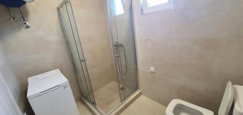 a bathroom with a shower and a toilet at Aqua Apartments in Bigovo