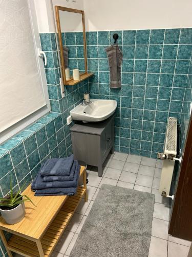 a bathroom with a sink and a mirror at Ferienwohnung am Waldrand mit großem Garten in Leverkusen