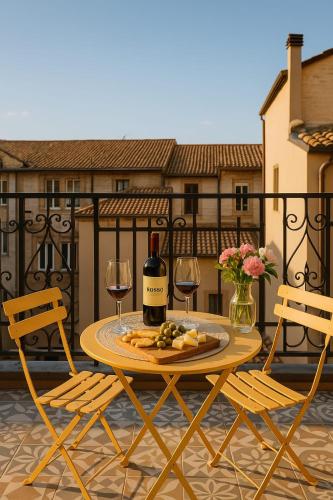 a table with glasses of wine and cheese on a balcony at CASA GAH in Ripatransone