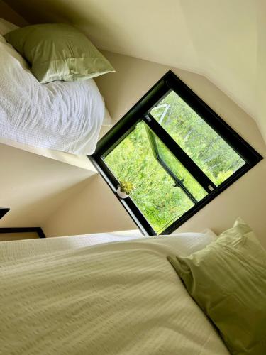 a bedroom with a window in the corner of a room at High standard and beautiful view in Tennevika