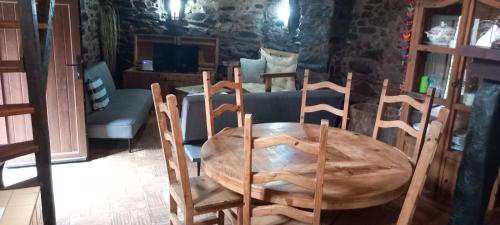 a wooden table and chairs in a room at Casa do Forno in Sobreira Formosa