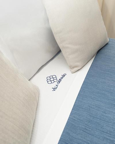 a close up of a bed with a pillow at Villa Gervasio Rooms in Bacoli
