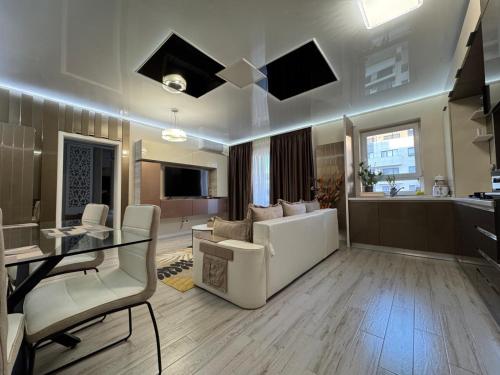 a large living room with a table and a couch at TAN GoLD in Constanţa