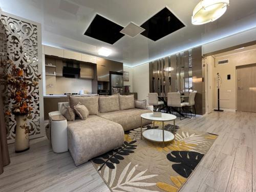 a large living room with a couch and a kitchen at TAN GoLD in Constanţa