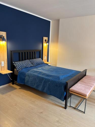 a bedroom with a bed with a blue bedspread at Indigo Apartment in Kassel