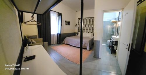 a bedroom with a bed and a mirror at Hotel Antigone in Tirana