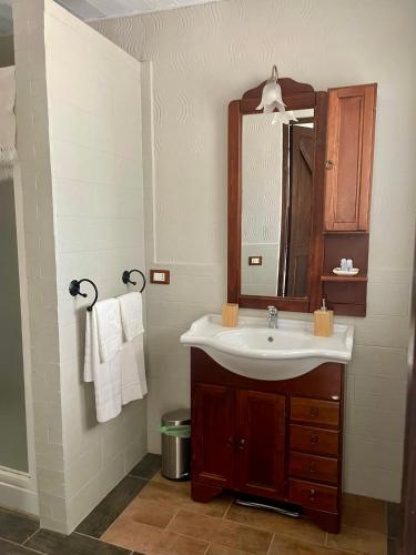 a bathroom with a sink and a mirror at Il Calesse - Noto in Noto