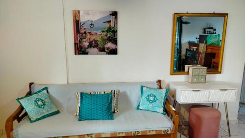 a living room with a couch and a mirror at Casa Nonna Traditional guest house in Oziás