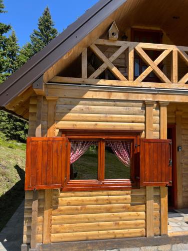 a log cabin with two windows and a door at Tvoja Kućica Za Beg in Banjska