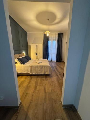 a bedroom with a bed and a wooden floor at Casa Camurria in Aci Castello