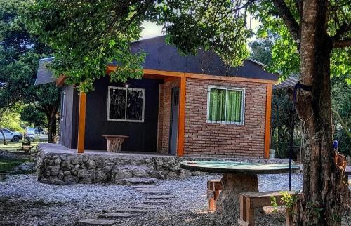 a small house with a table in front of it at Punto campestre in Cueva de los Pajaritos