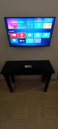 a flat screen tv sitting on top of a black stand at Nguchiro Palace Hotel in Moshi