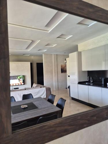 a kitchen and living room with a table and chairs at Villa-l-arganier - Piscine - Sans vis-à-vis in Eddir